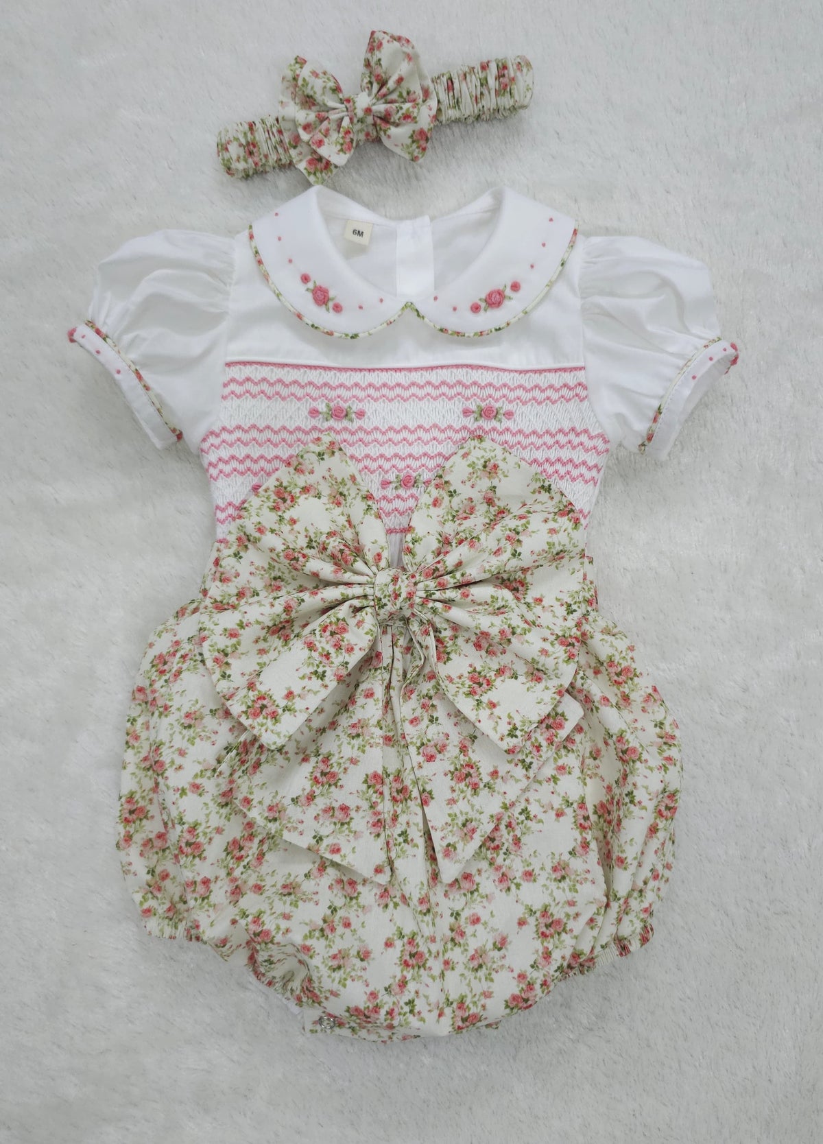 Pink floral hand smocked girls romper